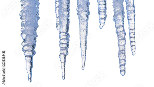 Fotografie Isolated multiple clear blue icicles with water drops and bubbles, detailed clos