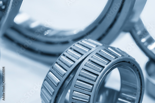 Photos Close-up of a high-precision taper rolling bearing component in a light blue-toned industrial scene
