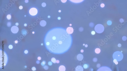 Beautiful festive background with magical soft glowing blue and silver bokeh light bubbles floating around. Concept of holiday magic and abstract dreaming