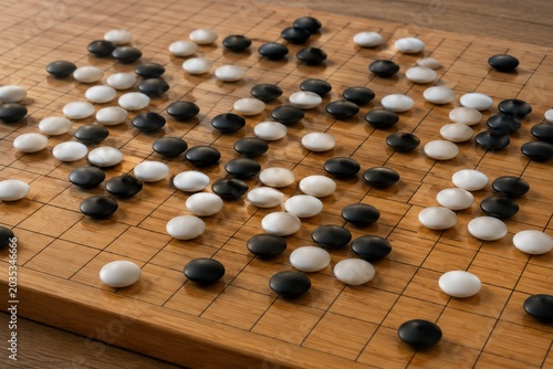 Go Board Game in Progress, Wide Angle View of Black and White Stones on Wooden Grid