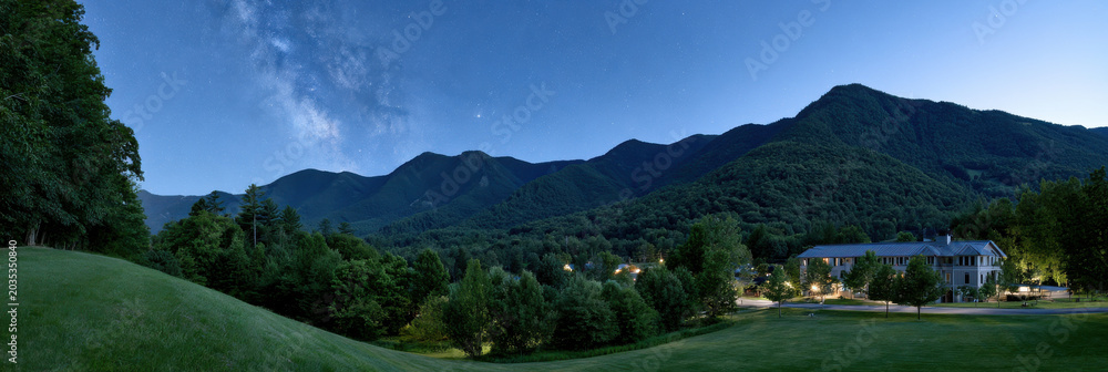 Fototapeta premium Summer landscape night sky milky way mountain forest valley village building tree star