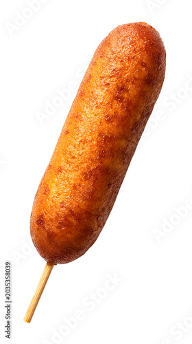 Golden brown corn dog on a wooden stick, crispy fried batter snack isolated on a light background.