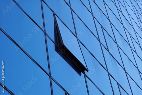 open window on glass facade of modern office building