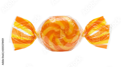 Orange and yellow candy in transparent wrapper with a swirling design, sweet treat delicious flavor.