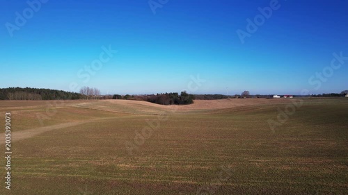 Low altitude forward drone flight over open farmland