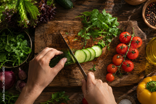 Fresh organic vegetables being prepared on a rustic wooden board