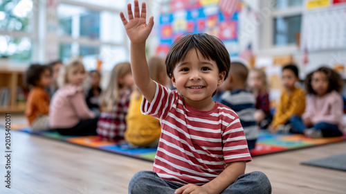 A realistic commercial stock photo of a diverse American classroom during morning circle time, in the foreground a mixed-race young male student with short dark hair wearing a red
