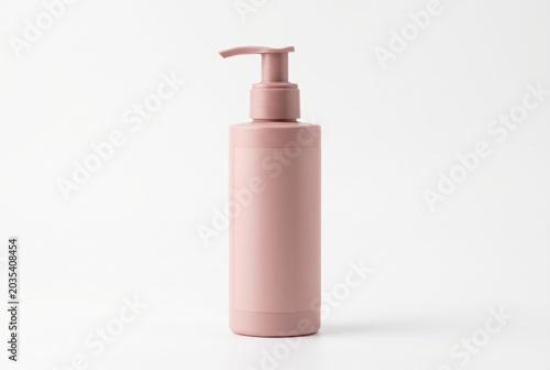 Minimal pink pump bottle on white background for skincare product mockup and clean cosmetic packaging design