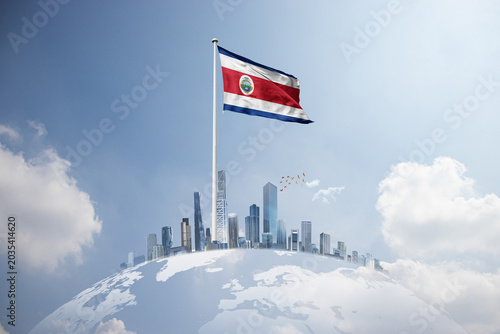 Photos Costa Rica flag wavering on globe with modern building skyline