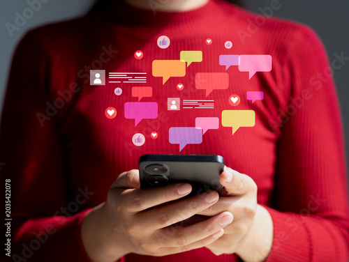A woman using a smartphone; the concept of digital communication through smartphone messaging, social media interaction, and online chat notifications.