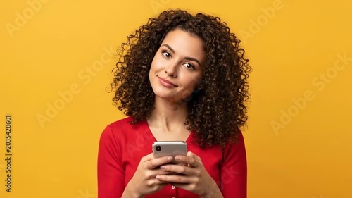 Woman intently focused on her smartphone with a concerned expression