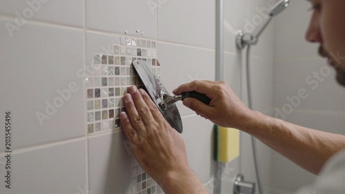 Worker Tiling Bathroom Shower Walls