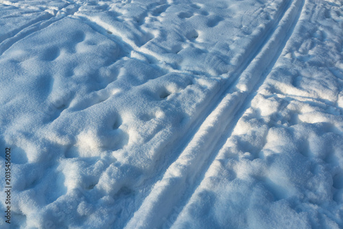 Straight ski tracks on clean blue snow