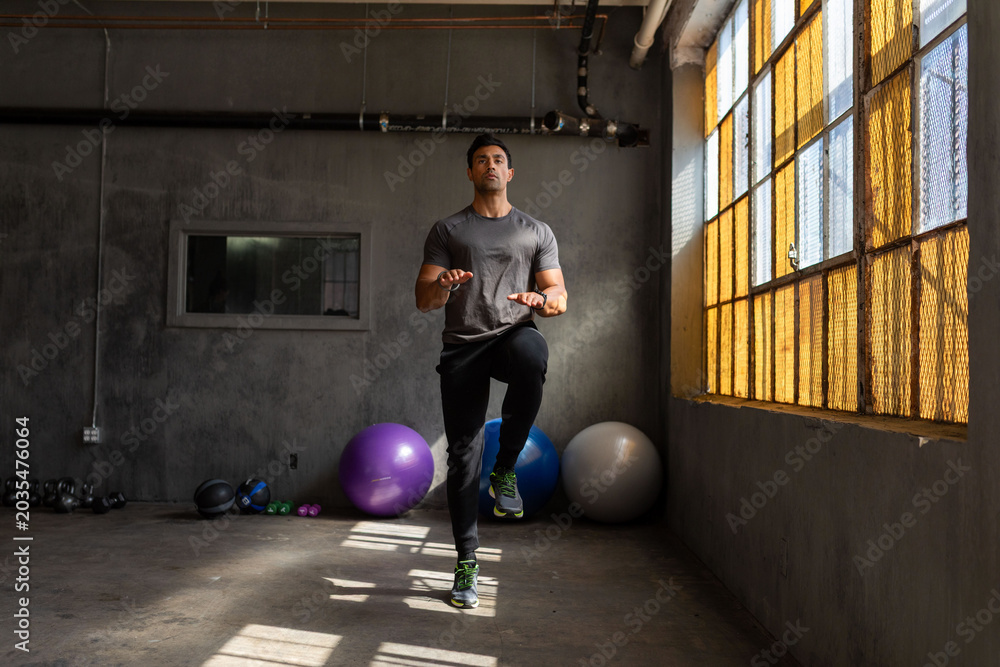 Fototapeta premium Man exercising in industrial gym