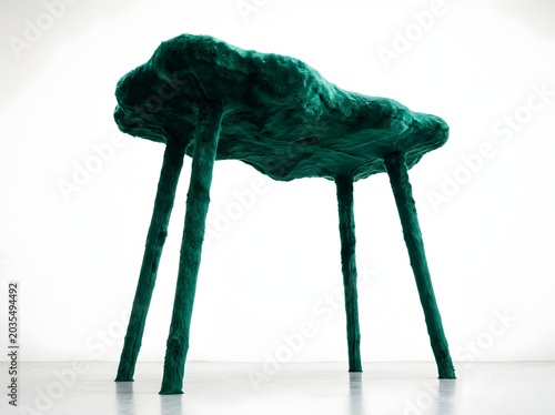 Unique Green Furred Four-Legged Furniture Piece on a White Background