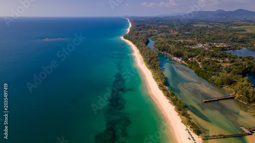 Photos High altitude drone view of coastal landscape with mountains, sea and fields