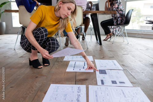 Photos Creative professional reviewing design plans.