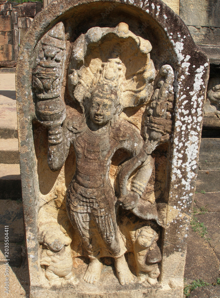 Fototapeta premium Ancient stone guardstone Muragala depicting a Dvarapala guardian with a multi-headed cobra hood, Sri Lanka