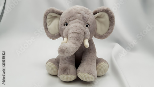 Baby Shoes with Teddy Bear Plush Toy on Wooden Floor Background