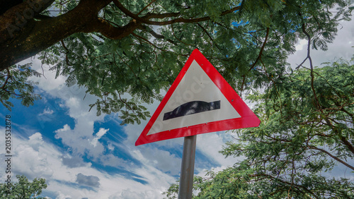 Tableau sur toile Speed hump ahead traffic road sign in a neighborhood.