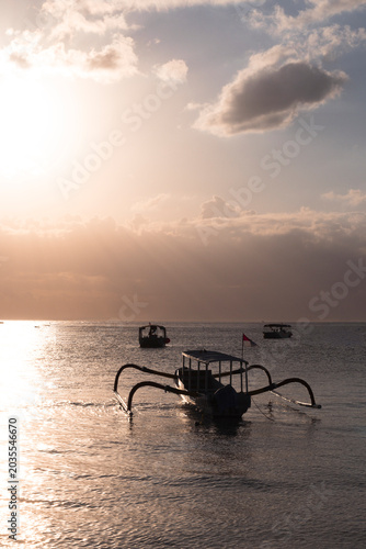 Traditional Balinese Jukung Boat at Sunset on Calm Tropical Sea, Nusa Lembongan, Indonesia