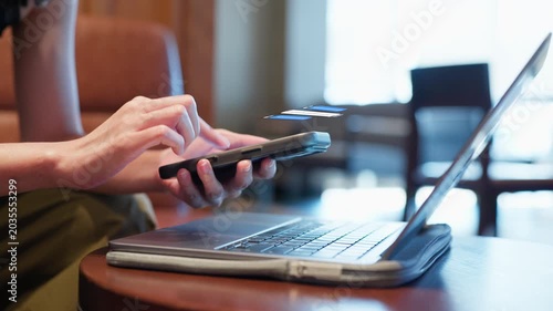 Woman Hand Using Smartphone for Online Chatting with Laptop