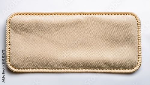A Light Beige Rectangular Fabric Label With A Stitched Border