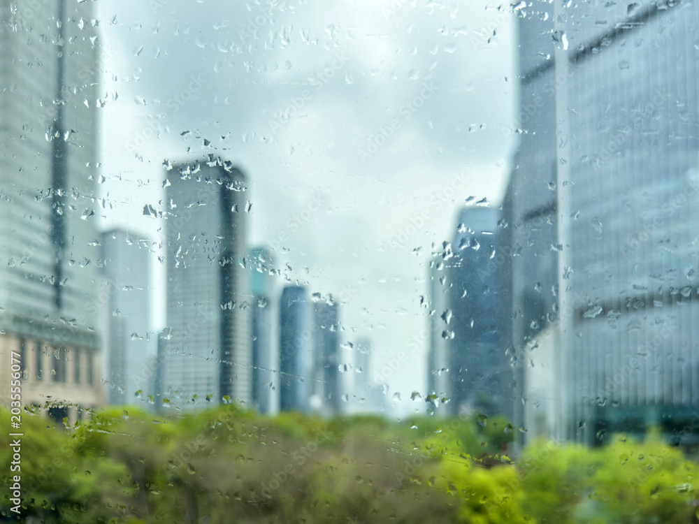 Obraz premium Rain speckled window with blurred high rise skyline in a China city