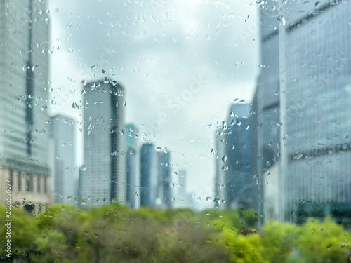 Rain speckled window with blurred high rise skyline in a China city