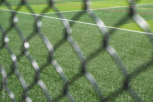 Copy space background soccer field empty public park, close up fence	