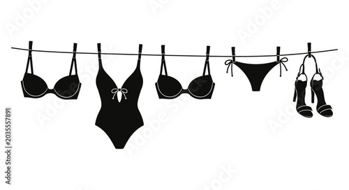 Bild auf Leinwand Bikini day collection black swimwear sandals hanging on clothesline isolated on