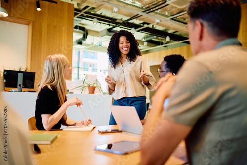 Canvas Print Multicultural business professional leading a team meeting, discussing ideas and