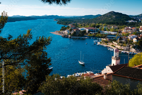 Croatian coastal town from above: vibrant marina, traditional houses, Sibenik Bridge spanning the Adriatic