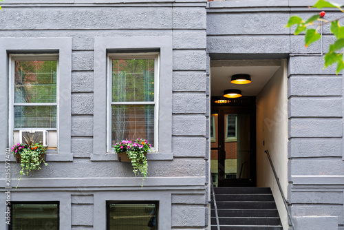 Quadro su tela Entrance to a classic residential apartment building with gray stucco facade and