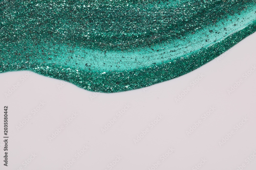 Obraz premium Green glitter nail polish on white background, top view. Space for text