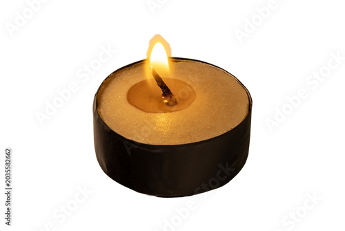 Fotografía Minimalist tealight candle flame glowing in dark black casing