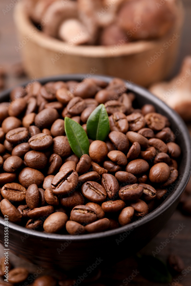 Fototapeta premium Coffee beans and mushrooms on table, closeup