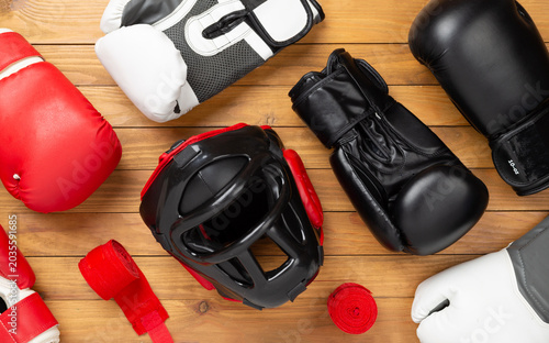 Konstfotografi Boxing helmet and gloves on wooden background, top view.