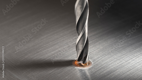 Obraz na płótnie drill bit with technical lubricant make hole in metal aluminum plate