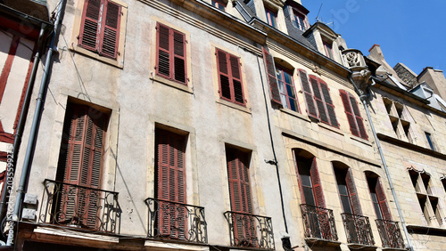 French Townhouse Facades with Tall Windows and Red-Brown Shutters