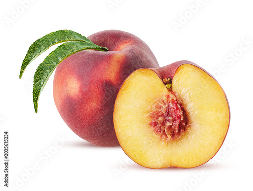 Peach fruit one cut in half with green leaf