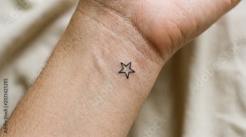 Tiny Minimalist Star Outline Tattoo on Inner Wrist	