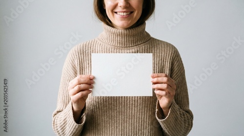 Woman in Sweater Holding Blank White Paper Card Mockup	