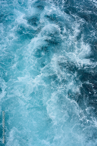 Blue sea water with spray
