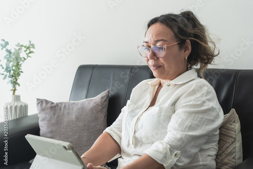 Woman connecting with tablet at home for communication