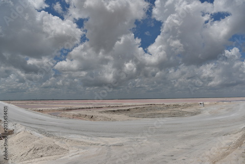 Expansive salt flat landscape under stormy clouds