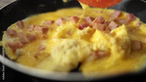 Scrambling Eggs With Ham In A Frying Pan.