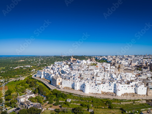Ostuni, the White City of Puglia. Aerial drone view of panorama of historic Italian architecture and Mediterranean landscape. Whitewashed old town