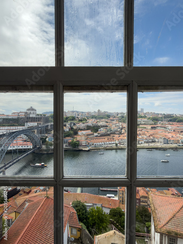View of Porto’s Douro River and Dom Luís I Bridge Through a Window