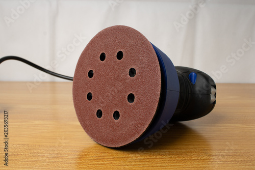 Orbital sander on a flat surface, sander isolated